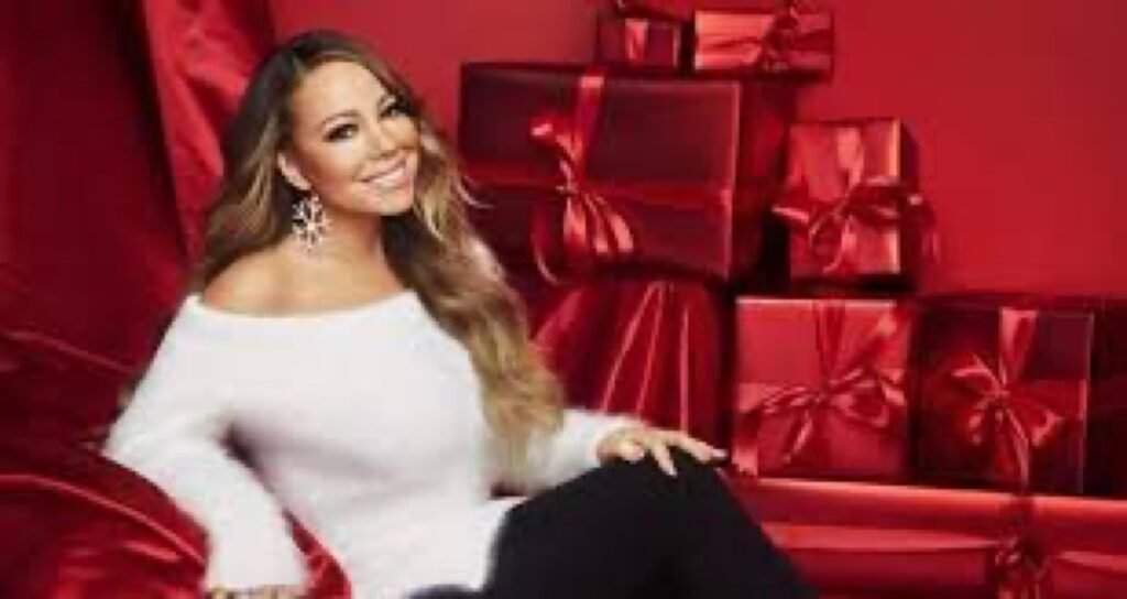 Mariah Carey seated beside red gift boxes for Amazon Prime Day deals