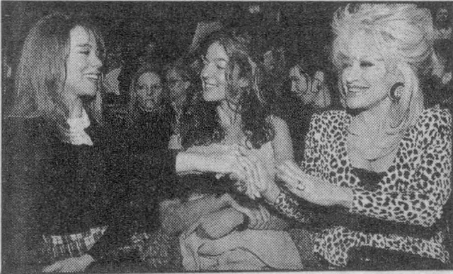 Mariah Carey greeting Dolly Parton at the Calvin Klein fashion show in 1994